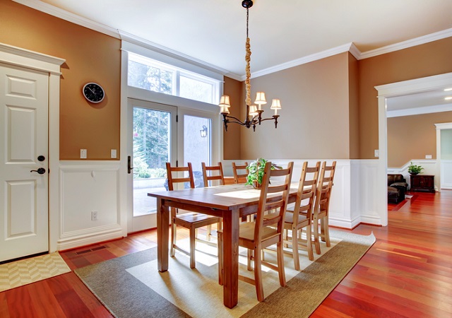 Large bright beige dining room with cherry hardwood.