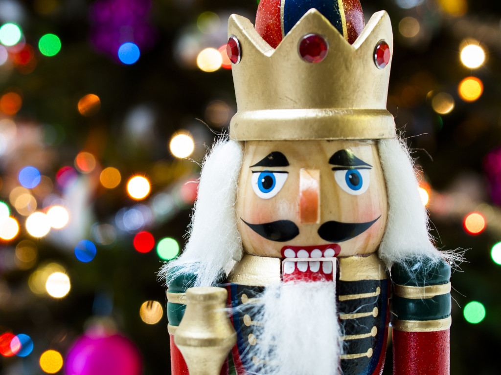 Nutcracker with Christmas tree in the backgound.